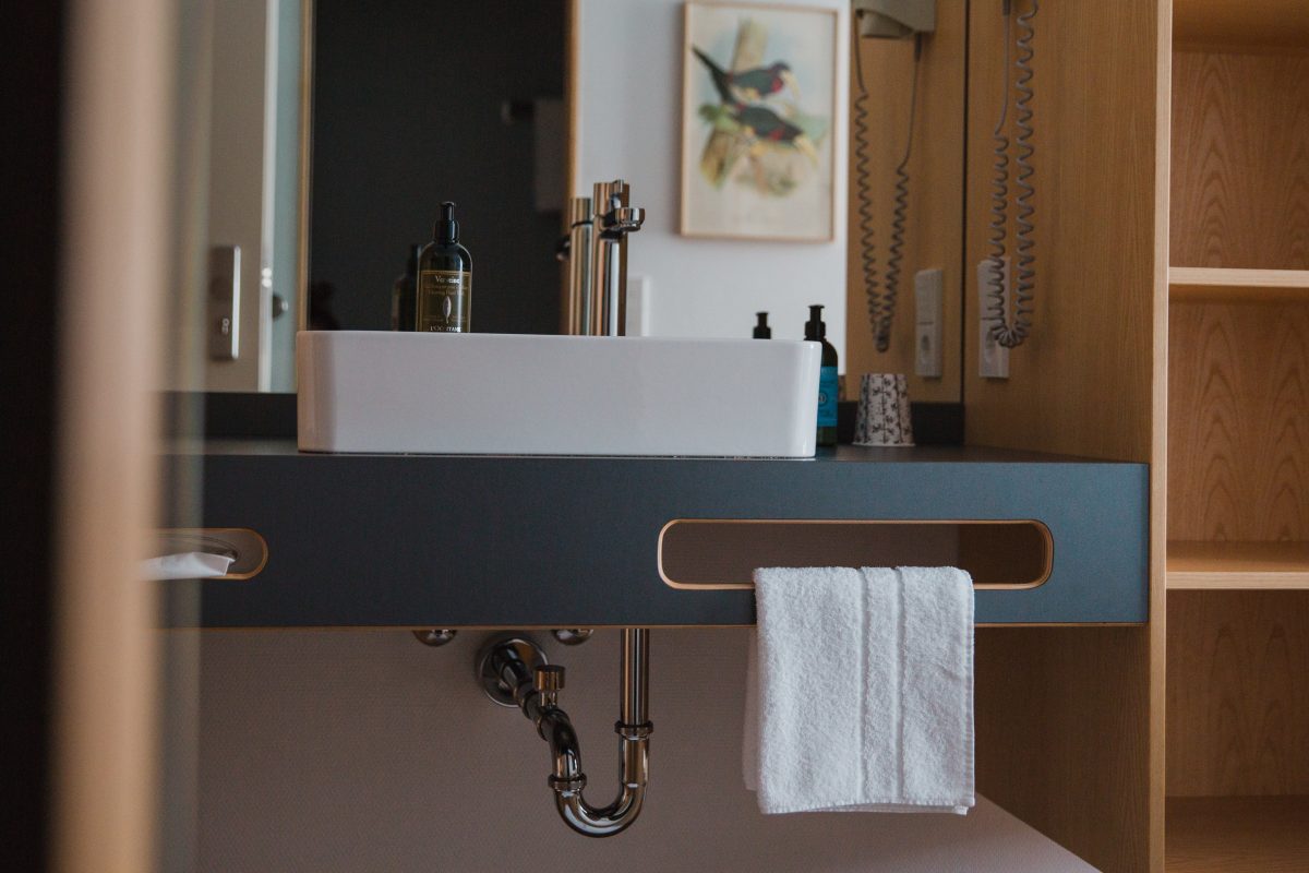 View of a sink in front of large mirror 