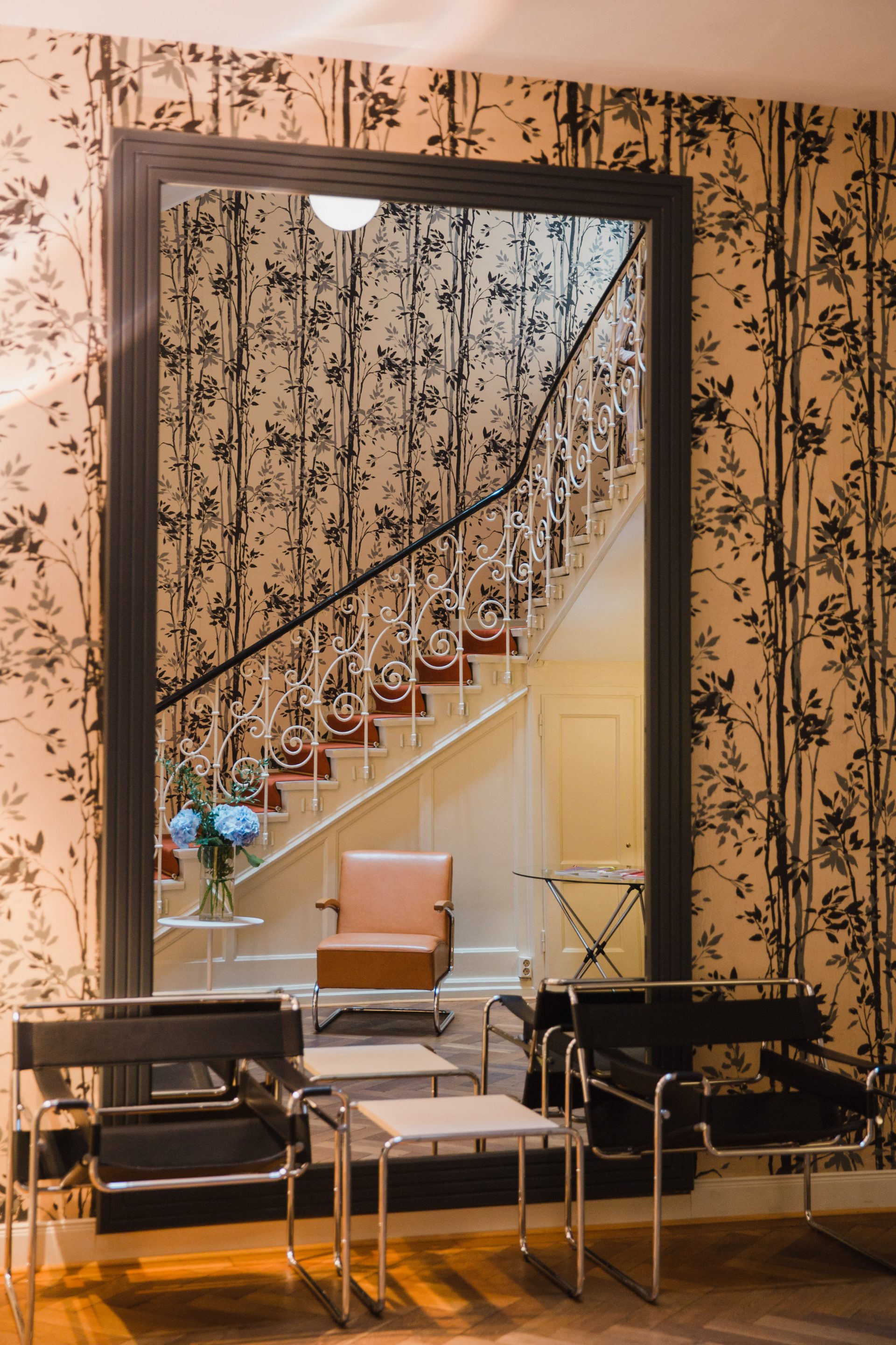 View on the mirror and artistic wallpaper in a staircase