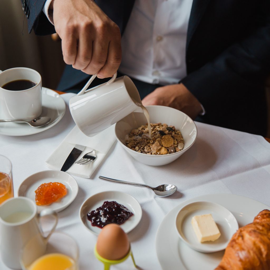 Businessman enjoying his breakfast in the hotel